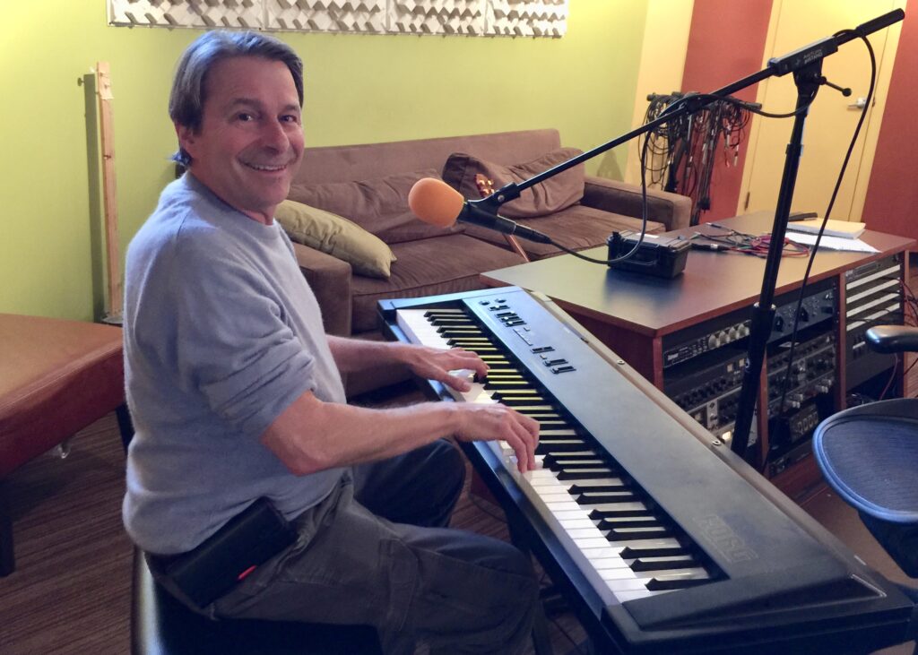 A Teaching Artist playing music on a keyboard
