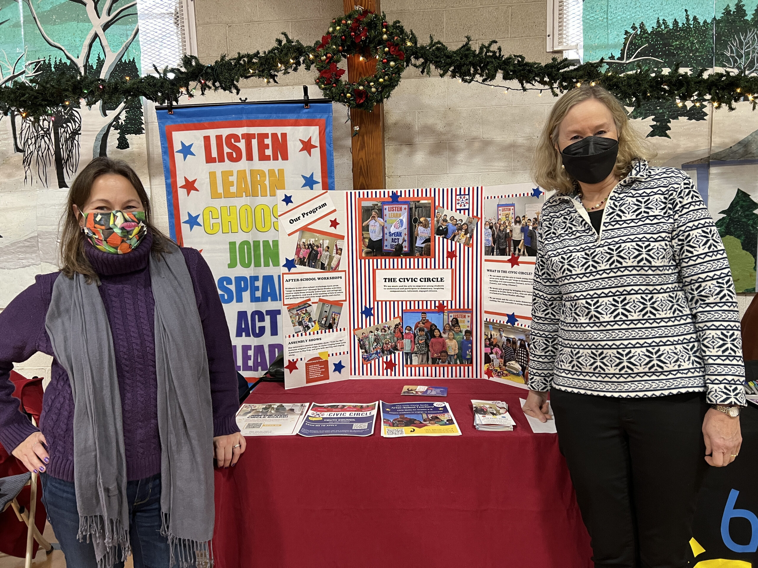 Two women standing in front of a table promoting The Civic Circle